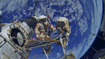 EVA Kotov and Ryazansky (with Olympic torch)