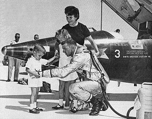 Joe Engle talks to his young son, Joe, after his X-15 astronaut flight on 29 June 1965. Joe's wife Mary, and daughter Laurie look on. Joe Engle talks to his young son, Joe, after his X-15 astronaut flight on 29 June 1965. Joe's wife Mary, and daughter Laurie look on.